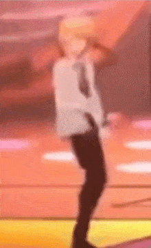 a blurred image of a person dancing on a stage