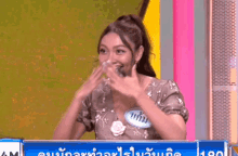 a woman with a name tag that says ' am ' on it laughs