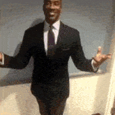 a man in a suit and tie is standing with his arms outstretched and smiling