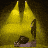 a yellow light is shining on a person 's face