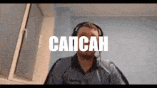 a man wearing headphones and a shirt that says capcan on it