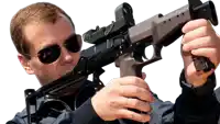 a man in sunglasses is holding a gun