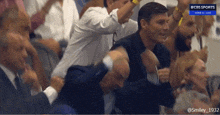 a group of people are watching a cbs sports live event