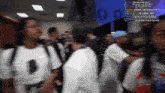 a blurry picture of a crowd of people with the number 0 on the wall behind them