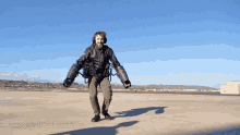 a man wearing a jetpack is walking on a runway with the website www.thehacksmith.ca visible in the corner