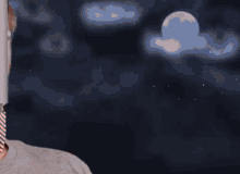 a man with a beard is making a funny face in front of a full moon .