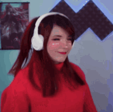 a girl wearing headphones and a red sweater