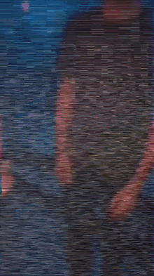 a blurry picture of a person 's face with a red light behind them .
