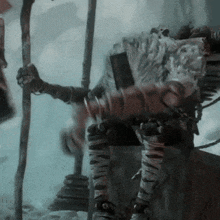a close up of a person holding a stick in a foggy room