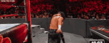 two men are wrestling in a wrestling ring with a crowd watching and a sign that says ironman match 10:02