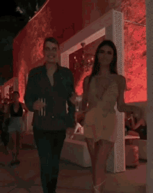 a man and a woman are dancing in a club
