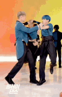a man with blue hair is dancing with another man with black hair