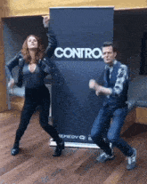 a man and a woman are dancing in front of a sign that says contra .