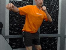 a man in an orange shirt that says change on it