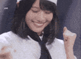 a woman wearing a chef 's hat and tie is smiling in front of a live screen