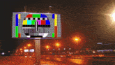 a billboard displays a colorful image of a tv screen