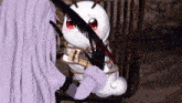 a cartoon character is tied up with a feather and is holding a bomb