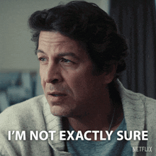 a man says i 'm not exactly sure with a netflix logo behind him