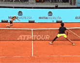 two tennis players on a court sponsored by mutua madrilena and lacoste