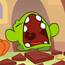 a cartoon character with a large mouth is surrounded by pieces of chocolate