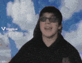 a man wearing sunglasses stands in front of a cloudy sky with the words viggle.ai visible in the corner