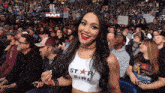 a woman in a crowd wearing a star girl crop top