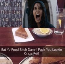a woman is screaming at a table with food and water