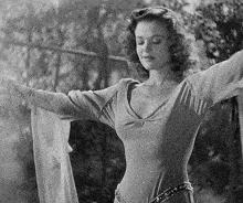 a black and white photo of a woman in a dress