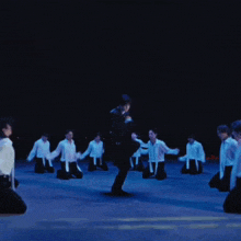 a man in a suit and tie is dancing with a group of men