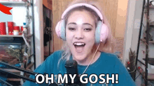 a woman wearing pink headphones is talking into a microphone and saying `` oh my gosh '' .