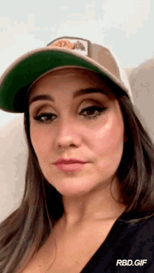 a woman wearing a hat that says rbd.gif on the bottom right