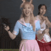 a woman in a sailor outfit is holding a gun while dancing .