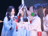 a group of girls are playing with a bow and arrow with a red question mark in the corner