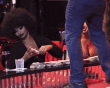 a woman sitting at a table with a glass of water