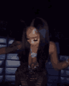 a woman in a leopard print top and pants is standing in a dark room