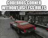 a car is driving down a street in front of a store called codebros corner without useless rules .