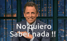 a man in a suit and tie is smiling and says no quiero saber nada !!