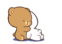 a couple of teddy bears standing next to each other .