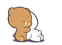 a couple of teddy bears standing next to each other .