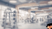 a blurry picture of a gym with a man in the foreground and the word workout in the background