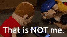 two stuffed animals looking at a cell phone with the text that is not me