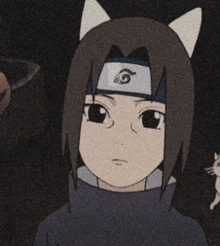 a young boy with cat ears is wearing a headband and standing next to a cat .