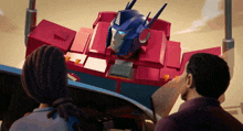 a man and woman are looking at a robot
