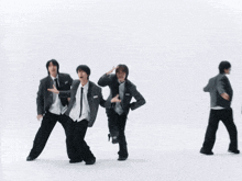 three boys in school uniforms and ties are dancing together