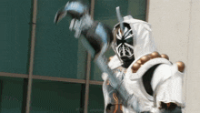 a statue of a man in a white and black costume holding a sword