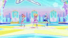 three anime girls are dancing on a stage in front of a crowd .