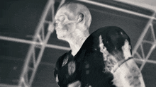 a black and white photo of a statue of a man with a skull on his head