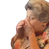 an elderly woman is covering her nose with her hands
