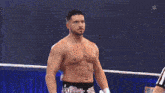 two wrestlers are in a ring with a large screen behind them that says nxt battleground las vegas