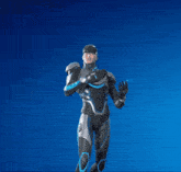 a man in a futuristic suit is reaching up in the air